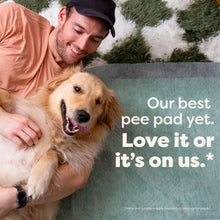 Man holding a happy dog with on pee pad with satisfaction guarantee
