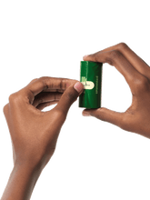 a hand holding an unscented refill roll